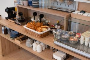 a shelf with a basket of bread and other food at Hotel Cosmos in Paris