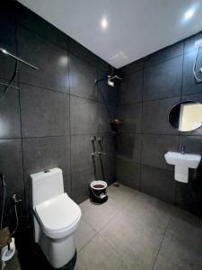 a bathroom with a toilet and a sink at Havana Beach Villa in Alleppey