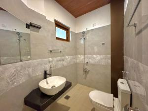 a bathroom with a sink and a toilet at The Dimora Residence in Kurunegala