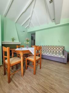 a room with a table and chairs and a couch at Traditional mama house in Skala Sotiros