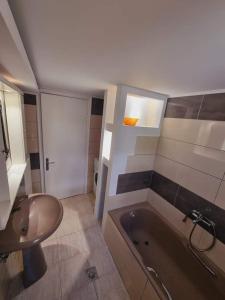 a bathroom with a sink and a bath tub at Traditional mama house in Skala Sotiros