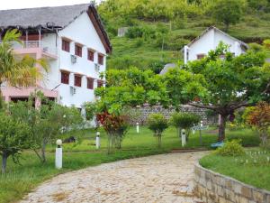 a house and a path in front of a building at Green Garden Lodge in Nosy Be