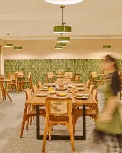a dining room with a wooden table and chairs at Minimalist - The Varanasi Edit in Varanasi +43 photos