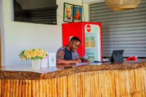 a man is sitting at a counter at a bar at Sea Eagle Oceanfront in Buyuni +271 photos