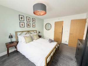 a bedroom with a large white bed and a mirror at Orchard Point in Southampton