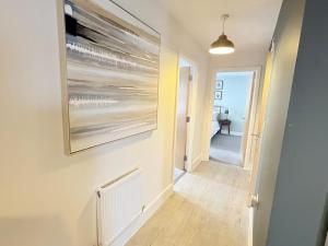 a hallway with a painting on the wall at Orchard Point in Southampton