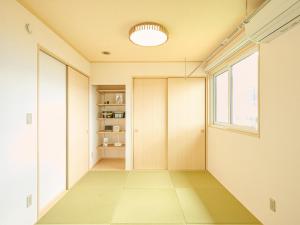 a hallway of a house with a door and a window at HUG me Ocean awaji in Sumoto