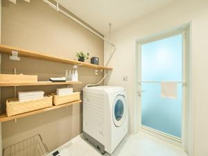 a washing machine in a room with a window at HUG me Ocean awaji in Sumoto