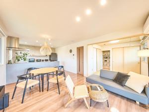 a living room with a couch and a table at HUG me Ocean awaji in Sumoto