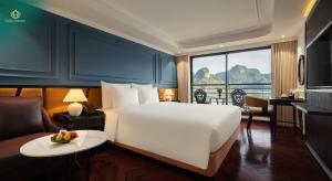 a hotel room with a bed and a table with a bowl of fruit at Diana Cruises Halong Bay - Luxury by Venus Group in Ha Long +84 photos