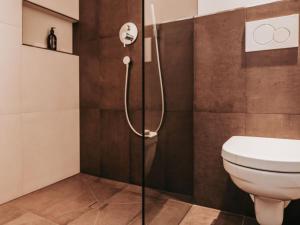 a bathroom with a toilet and a shower at Hotel Schönberg in Rio Bianco +39 photos