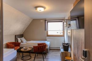 a hotel room with a bed and a table and chairs at Chaplin in Kempten