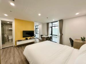 a hotel room with a large bed and a bathroom at GEM Hotel And Residence in Hanoi