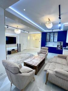 a living room with a couch and a table and chairs at Boulevard in Samarkand