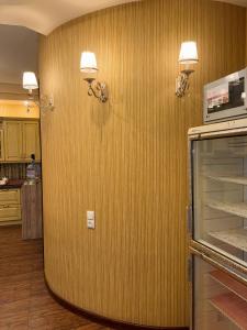 a kitchen with a wall with two lights on it at Узбечка in Tashkent