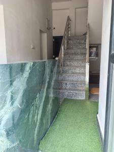 a set of stairs with a green floor at Hotel Aditya Bikaner in Deshnoke