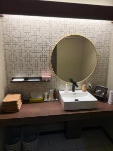 a bathroom with a sink and a mirror on a counter at 6名泊まれて鼓動を感じるシティウォークの拠点に-voyage- in Kumamoto +19 photos