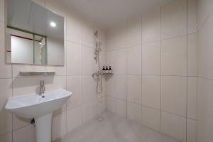 a white bathroom with a sink and a mirror at Anook Hotel Jeonju in Jeonju +68 photos