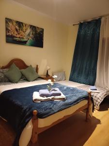a bedroom with a bed with two towels on it at Q1 Blueroom Sofia's Happy Apartment in Loulé