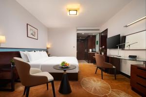 a hotel room with a bed and a table and chairs at Liuhua Hotel in Guangzhou
