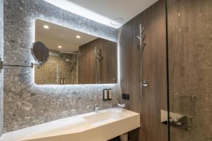 a bathroom with a sink and a mirror at Amberton Cathedral Square Hotel Vilnius in Vilnius +75 photos