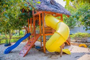 a playground with a slide and a play structure at Sea Eagle Oceanfront in Buyuni