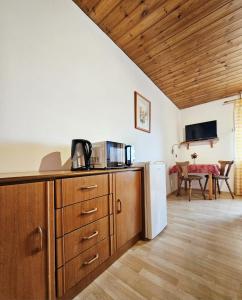 a kitchen with a refrigerator and a table at Pension Haus Donaublick in Deggendorf