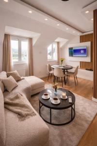 a living room with a couch and a table at Garden lux in Belgrade