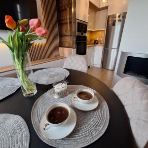 two cups of coffee on a table in a kitchen at Garden lux in Belgrade