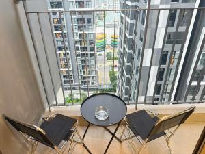 a table and chairs in a room with a large window at Homestay Ocean Park Building P3 in Gia Lâm Pho