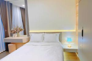 a bedroom with a white bed and a window at Homestay Ocean Park Building P3 in Gia Lâm Pho