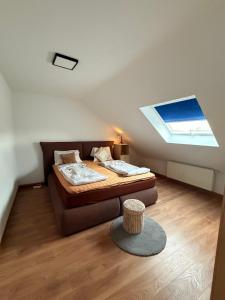 a bedroom with a bed and a skylight at BM Wohnung in Dillingen an der Saar