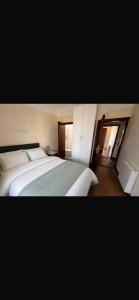 a bedroom with two white beds and a window at The Malting House in Skerries