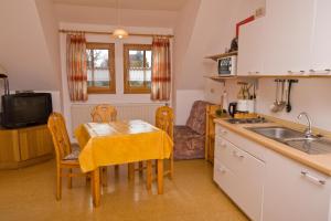 a small kitchen with a table and a sink at Wohlfühlbauernhof in Geslau