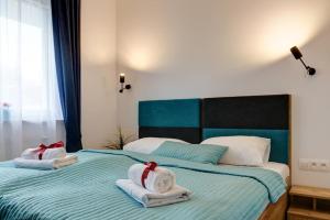 a bedroom with two towels on a bed at Apartamenty Marina Jastarnia Bis in Jastarnia +22 photos