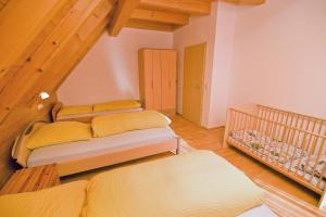 a room with three beds and a staircase at Wohlfühlbauernhof in Geslau
