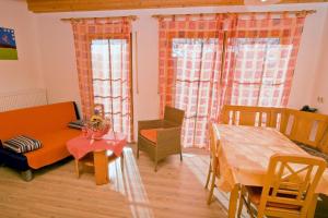 a living room with a couch and a table and chairs at Wohlfühlbauernhof in Geslau