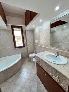 a bathroom with a tub and a sink and a toilet at Corso Messina in Crotone