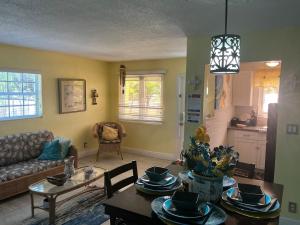 a living room with a table and a couch at Jubilee Gardens Freeport in Freeport