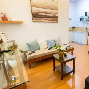 a living room with a couch and a table at Villa de Maria Suites in Binungan