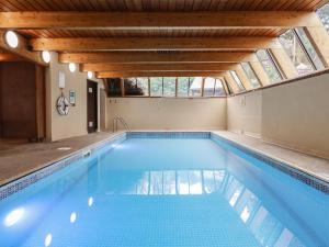 a swimming pool with a skylight in a house at Watermouth Castle, West Tower Apartment in Ilfracombe