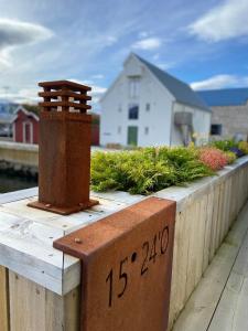 a wooden fence with a brick meter on it at Scandic Sortland in Sortland