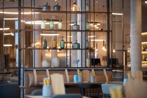 a restaurant with a table with vases on a shelf at Scandic Sortland in Sortland