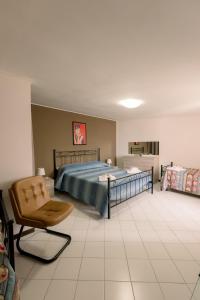 a bedroom with a bed and a chair at Pollutrendy in Pollutri +241 photos