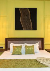 a bedroom with a large bed with two pillows at Dimora Hideout in Homagama