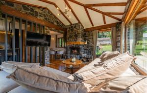 a living room with a couch and a stone wall at Pet Friendly Home In Debelo Brdo With Sauna in Debelo Brdo