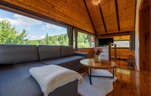 a living room with a couch and a table at Pet Friendly Home In Debelo Brdo With Sauna in Debelo Brdo