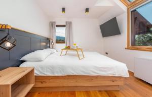a bedroom with a large bed and a table at Pet Friendly Home In Debelo Brdo With Sauna in Debelo Brdo