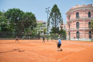a group of people playing tennis on a tennis court at Hotel Yak & Yeti in Kathmandu