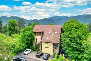 an aerial view of a house with cars parked in a parking lot at Relax in Style Boutique Hotel in Braşov